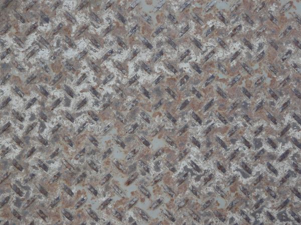 Old metal tread texture with repeating pattern and very worn surface.